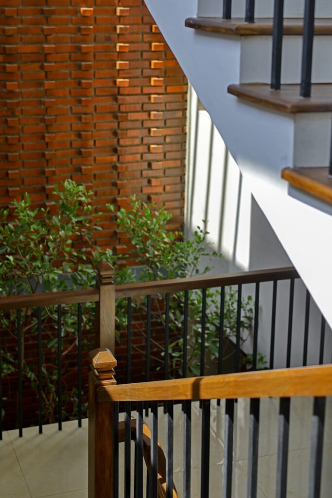 a stair case next to a wooden hand rail